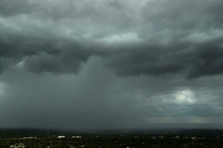 Heavy rain falling down from stormy clouds over rural Florida suburbs. Thunderstorm on dark sky....