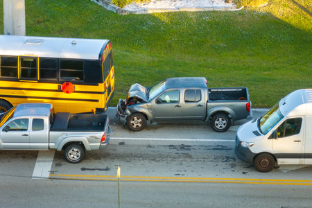 School bus and pick-up truck car crash with first responders helping at accident site on American...