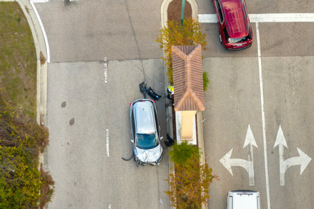 Traffic accident on American street in Florida. First responders helping victims of car crash on...