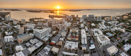 Aerial view of Sarasota city downtown at sunset with bay marina yachts and high-rise office buildings. Real estate development in Florida. USA travel destinationの写真素材
