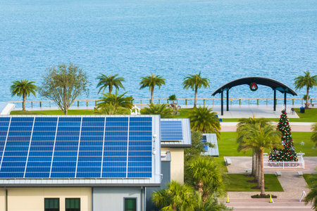 Autonomous building in Florida with photovoltaic rooftop covered with solar panels for producing of clean ecological electrical energy in town centerの写真素材