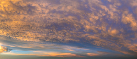 Getting dark at sundown. Sunset sky with scattered clouds of bright colors