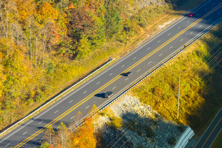 Highway road in American rural area. Expressway lanes for fast passing of car trafficの写真素材