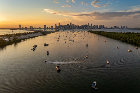 Miami, Florida. Biscayne Bay harbor with many yachts and motor boats. Enjoying sunset over city skyline with high-rise buildings in downtownの写真素材