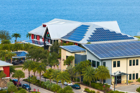 Solar photovoltaic panels installed on top of Florida office buildings for producing clean ecological electric energy. Renewable electricity with zero emission conceptの写真素材