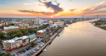 Waterfront River Street in Savannah, Georgia. Historic American architecture of old historical city. USA Southern cityscape at sunsetの写真素材