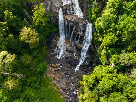 Aerial view of Whitewater Falls in Nantahala National Forest, North Carolina, USA. Clear water falling down from rocky boulders between green lush woodsの写真素材