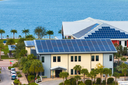 Autonomous buildings in Florida with photovoltaic rooftops covered with solar panels for producing of clean ecological electrical energy in town centerの写真素材
