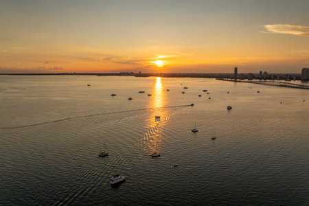 Biscayne Bay harbor with many yachts and fishing boats in Miami, Florida. Enjoying sunset over city skyline with skyscraper buildings in downtownの写真素材