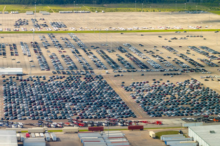 Cars parked ready for sale on automotive factory parking lotの写真素材