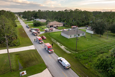 Firefighter trucks at fire alarm scene of suburban house. First responders at potential fire hazard at Florida homeの写真素材