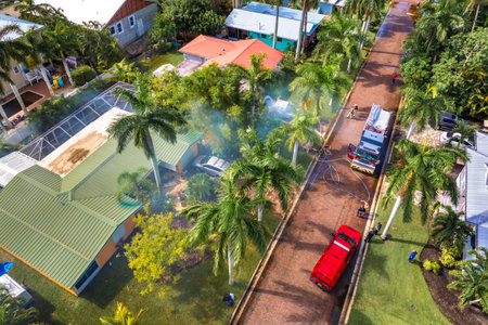 Firefighters extinguishing car fire on suburban street in Floridaの写真素材