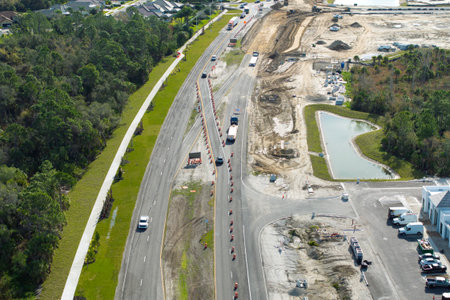 Industrial construction roadworks with moving cars in Venice, Florida. Development of urban transportationの写真素材
