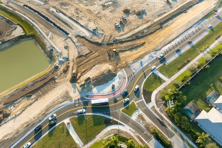 Roundabout construction roadworks on American transport infrastructure. Renovation of highway road with moving traffic. Development of interstate transportation conceptの写真素材