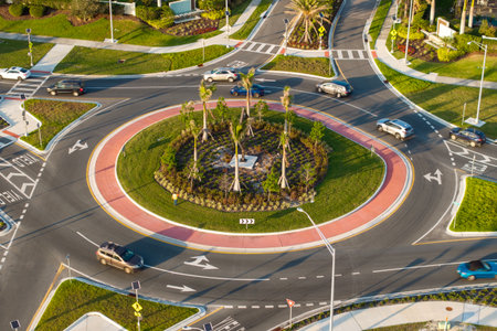 Roundabout crossroads on American city street with moving traffic cars. Circular transportation crossroads in USAの写真素材
