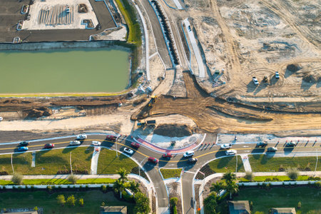 Roundabout intersection construction in North Port, Florida. Development of American road circle with moving traffic cars. Urban circular transportation crossroadsの写真素材