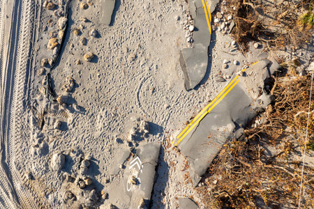 Storm surge destroyed oceanfront road on Gulf coast after hurricane in Florida. Severe damage to transportation infrastructureの写真素材