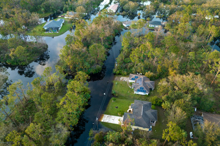 Surrounded by hurricane rainfall flood waters homes in Florida residential area. Aftermath of natural disasterの写真素材