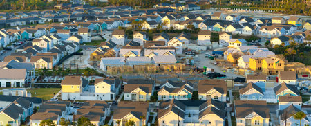 Wooden frames of new cheap American homes under construction. Development of residential housing in the USAの写真素材