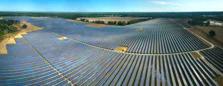 Aerial view of big sustainable electric power plant with many rows of solar photovoltaic panels for...