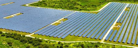 Aerial view of big sustainable electric power plant with many rows of solar photovoltaic panels for...