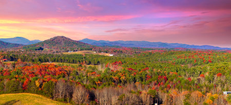 Bright yellow forests surround quiet rural homes on hillsides of North Carolina Appalachian mountains in fall season.の写真素材