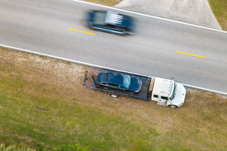Car accident on city street in Florida. Emergency services and tow truck at vehicle crash in USAの写真素材