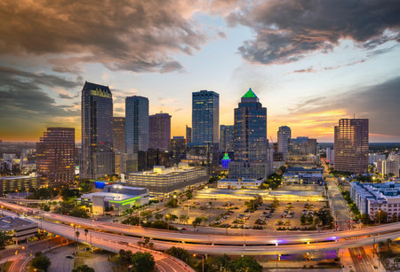 Downtown district of Tampa city in Florida, USA after sunset. Brightly illuminated highway and high buildings in modern American urban area.の写真素材