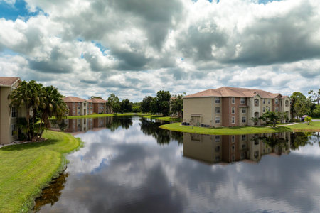 Family houses with retention ponds to prevent flooding in Florida closed suburban area. Real estate development in American suburbsの写真素材