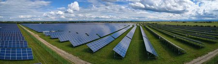 Aerial view of big sustainable electric power plant with many rows of solar photovoltaic panels for...