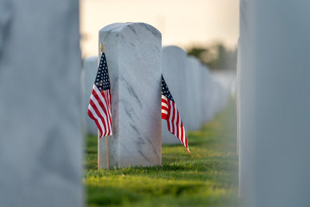 American army Sarasota National Cemetery with rows of white tombstones and USA flag on green grass....