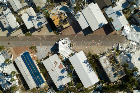 Hurricane destroyed suburban houses roofs in Florida mobile home residential area. Consequences of...