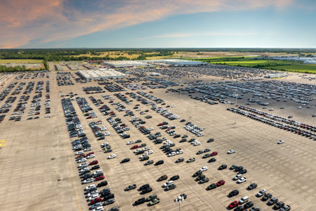 New cars for distribution at factory parking lot