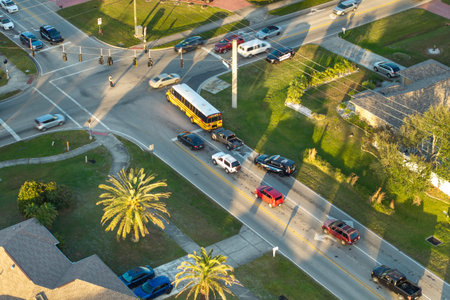 Traffic crash with damaged school bus and car on USA city street