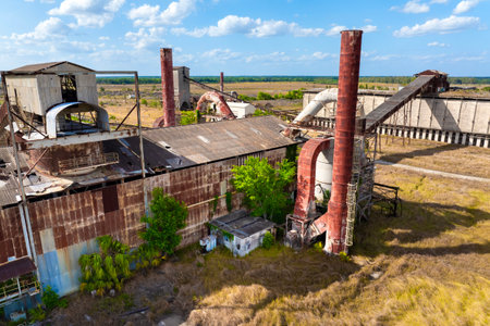 Old phosphate processing plant in central Florida with weathered structure, conveyor belts and...