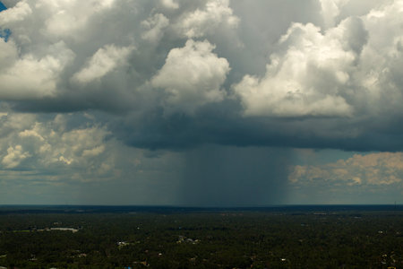 Tropical storm in Florida. Stormy clouds forming during heavy thunderstorm on dark sky. Moving and...