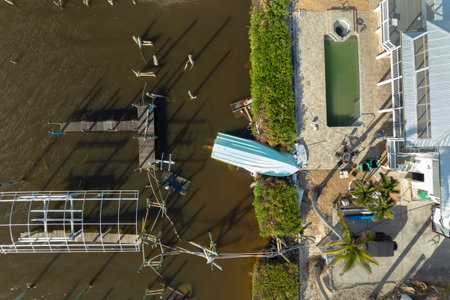 Capsized yachts left forsaken on shore after hurricane Milton on Manasota Key in Englewood, Floridaの写真素材