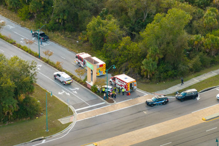 Car accident on highway road in Florida. Emergency services personnel helping victims of vehicle...