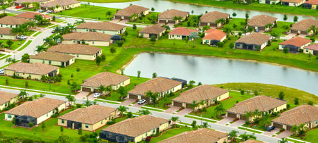 Aerial view of tightly located family houses with retention ponds to prevent flooding in Florida...