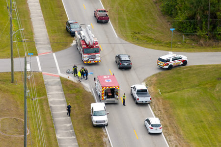 Traffic accident on American street. First responders and emergency medical technicians helping...