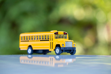Little model of american yellow school bus outdoor. Concept of education safety in the USA