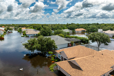 Flooded residential area with underwater houses from hurricane Debby rainfall water in Laurel Meadows community in Sarasota, Florida. Aftermath of natural disaster in southern USAの写真素材