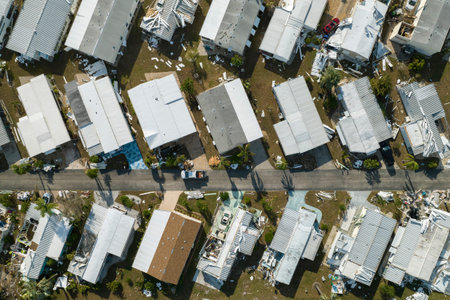 Strong hurricane winds severely damaged private houses in Florida mobile home residential area. Consequences of natural disasterの写真素材