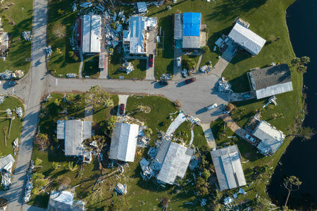 Consequences of natural disaster. Severely damaged houses after hurricane Ian in Florida mobile home residential areaの写真素材