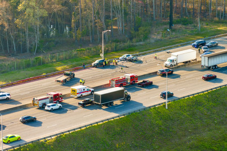 Car accident on high speed freeway road in Kentucky. Emergency services personnel helping victims of...