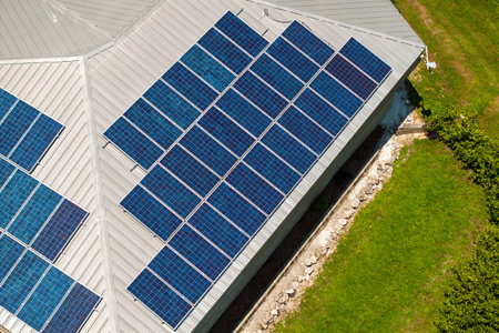 Residential house with rooftop covered with solar photovoltaic panels for producing of clean...
