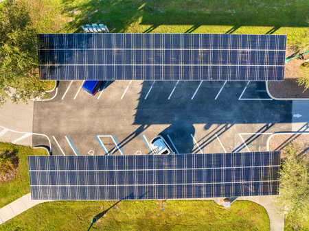 Photovoltaic canopy over parking area producing renewable electricity. Solar panels provide shade...