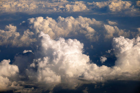 Rain clouds forming at high altitude. View from plane window at high altitude of sky. Air travel...