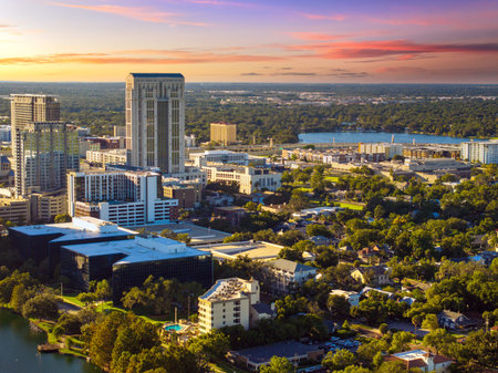 Panoramic aerial view of downtown Orlando surrounded by modern office buildings. Dense urban landscape showcases contemporary architecture and infrastructure.