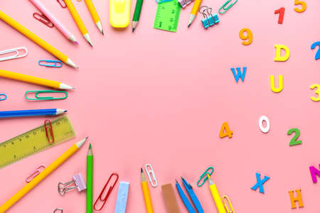 Many different school supplies on pink background. Back to school concept.の写真素材